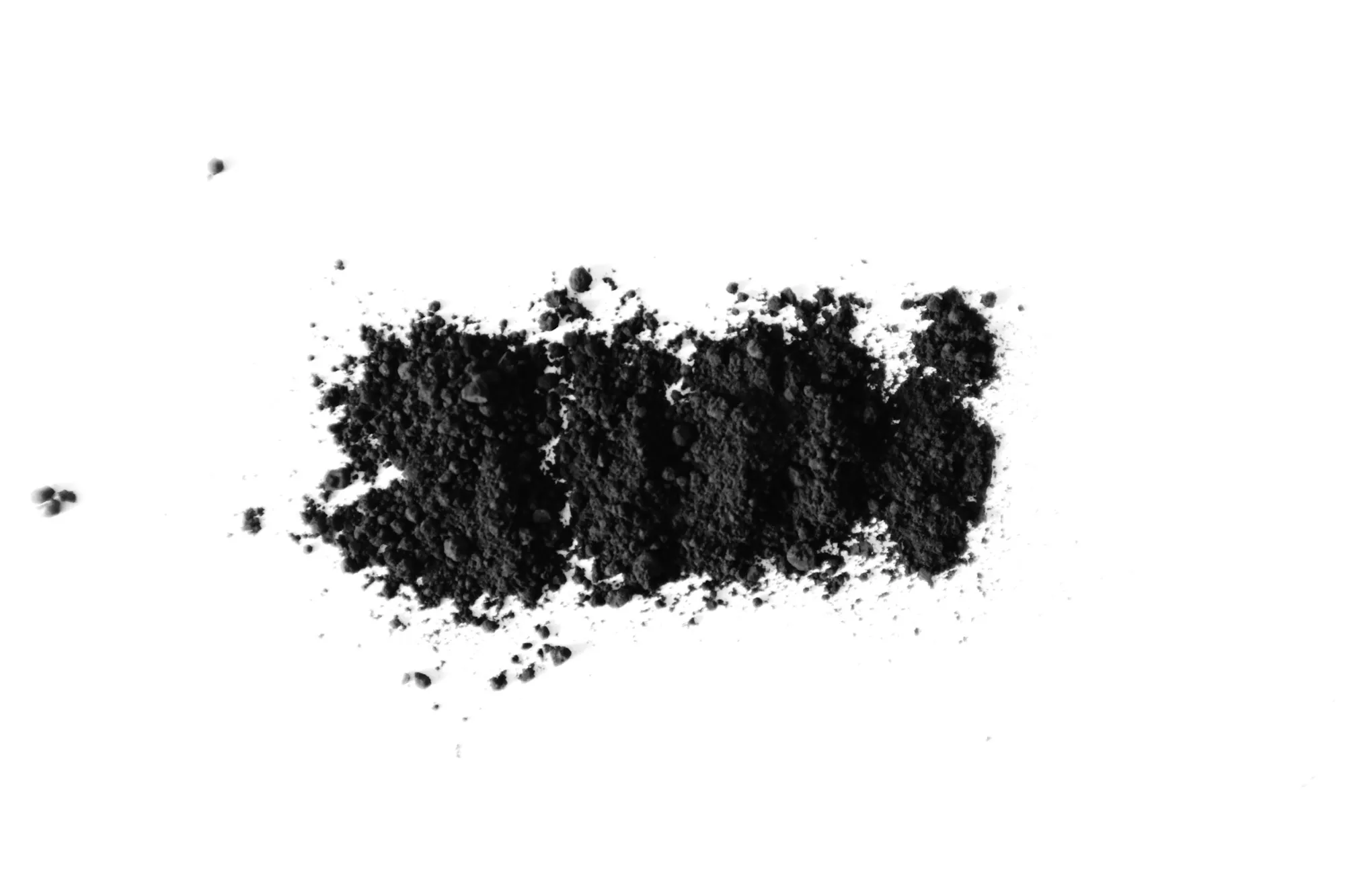 Carbon filtration systems in Laguna Hills Black activated carbon powder on a white surface