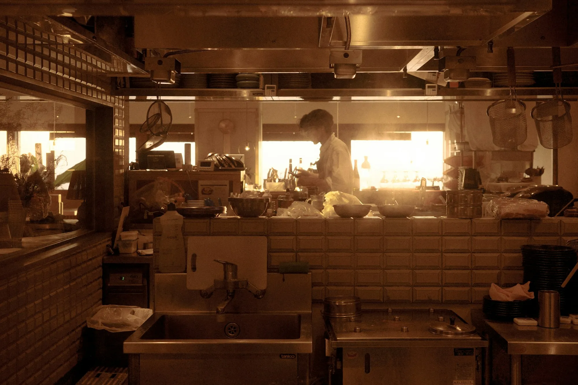 Commercial water filtration in Laguna Hills Chef working in a bright, sunlit restaurant kitchen