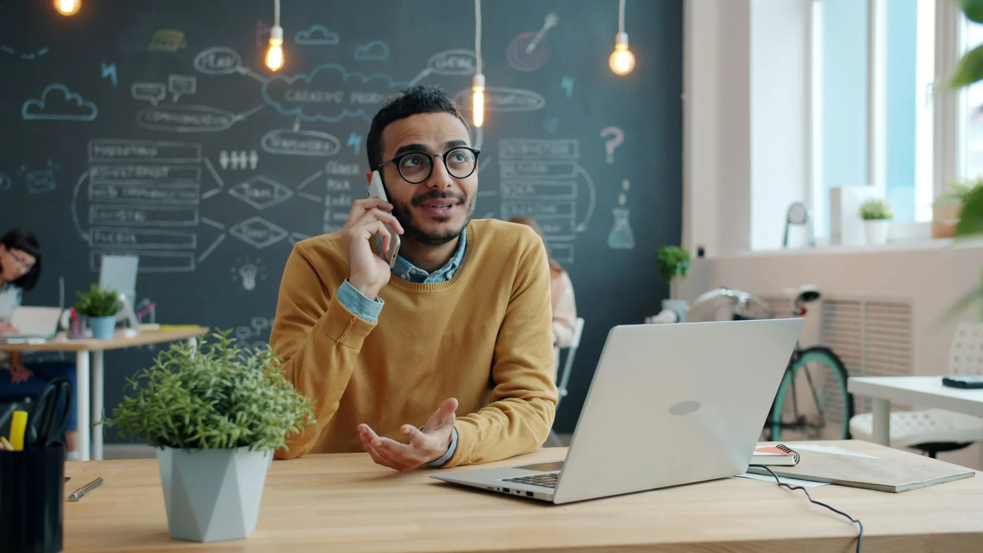 Contact Laguna Hills Water Pros Man talking on the phone at a desk with a laptop
