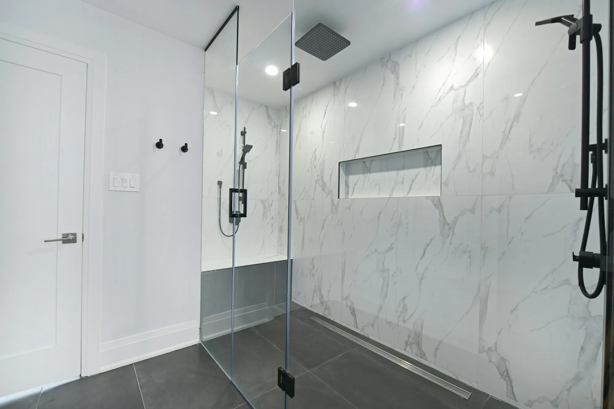 Water softener installation in Laguna Hills Modern bathroom with a glass-enclosed shower and marble walls