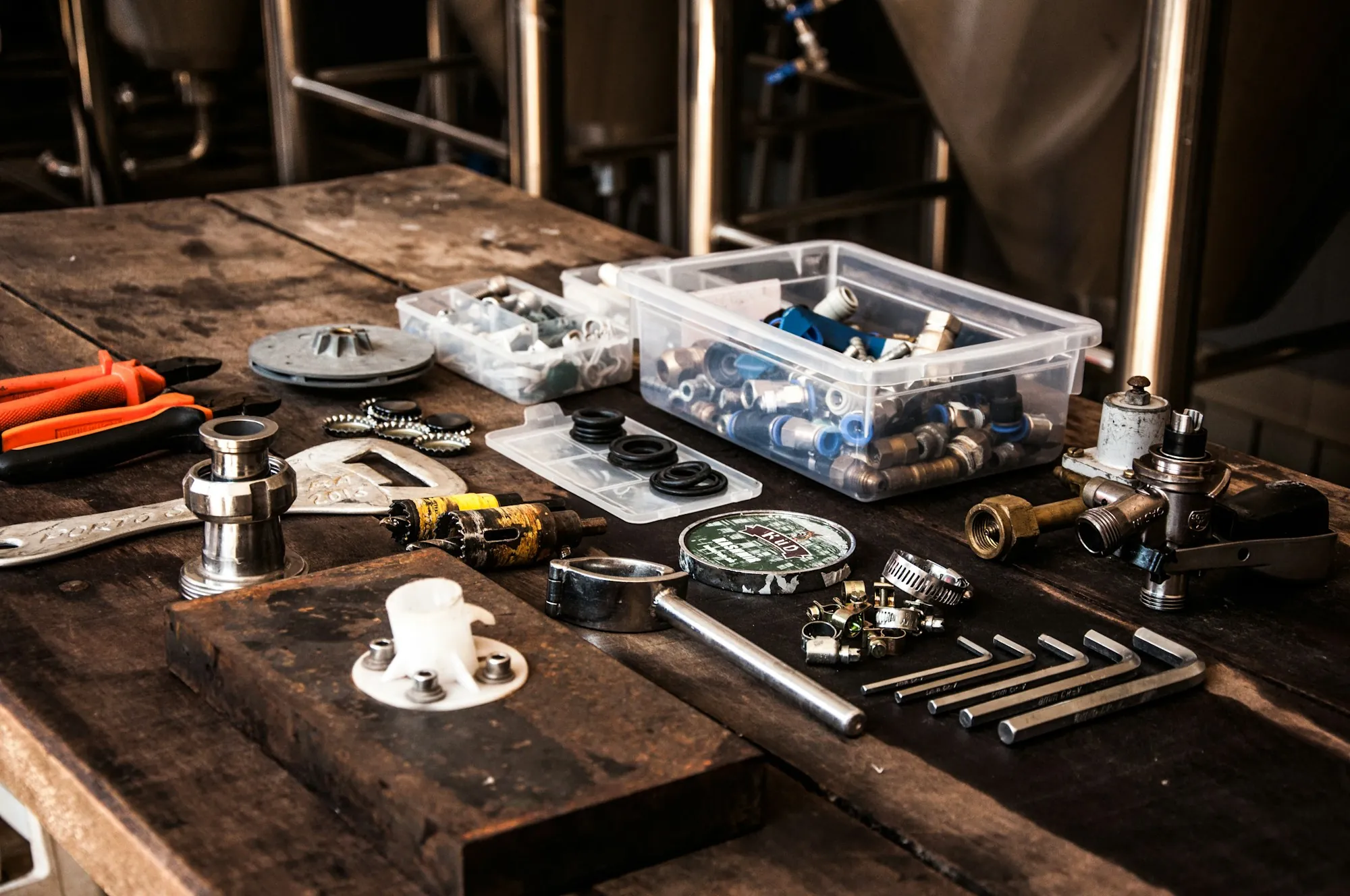 Water filter repair and maintenance in Laguna Hills Plumbing fittings and hand tools laid out on a workbench