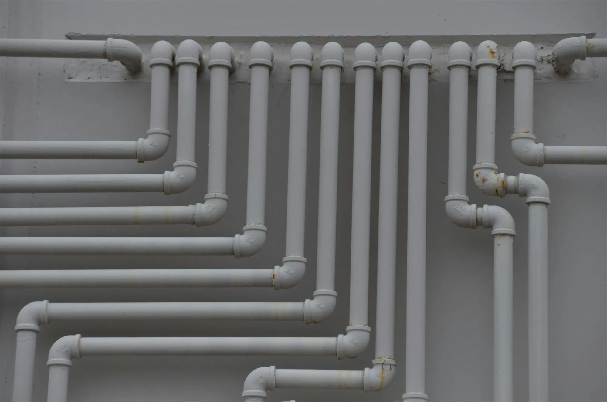 Whole-house water filtration in Laguna Hills Rows of water supply pipes running along a wall
