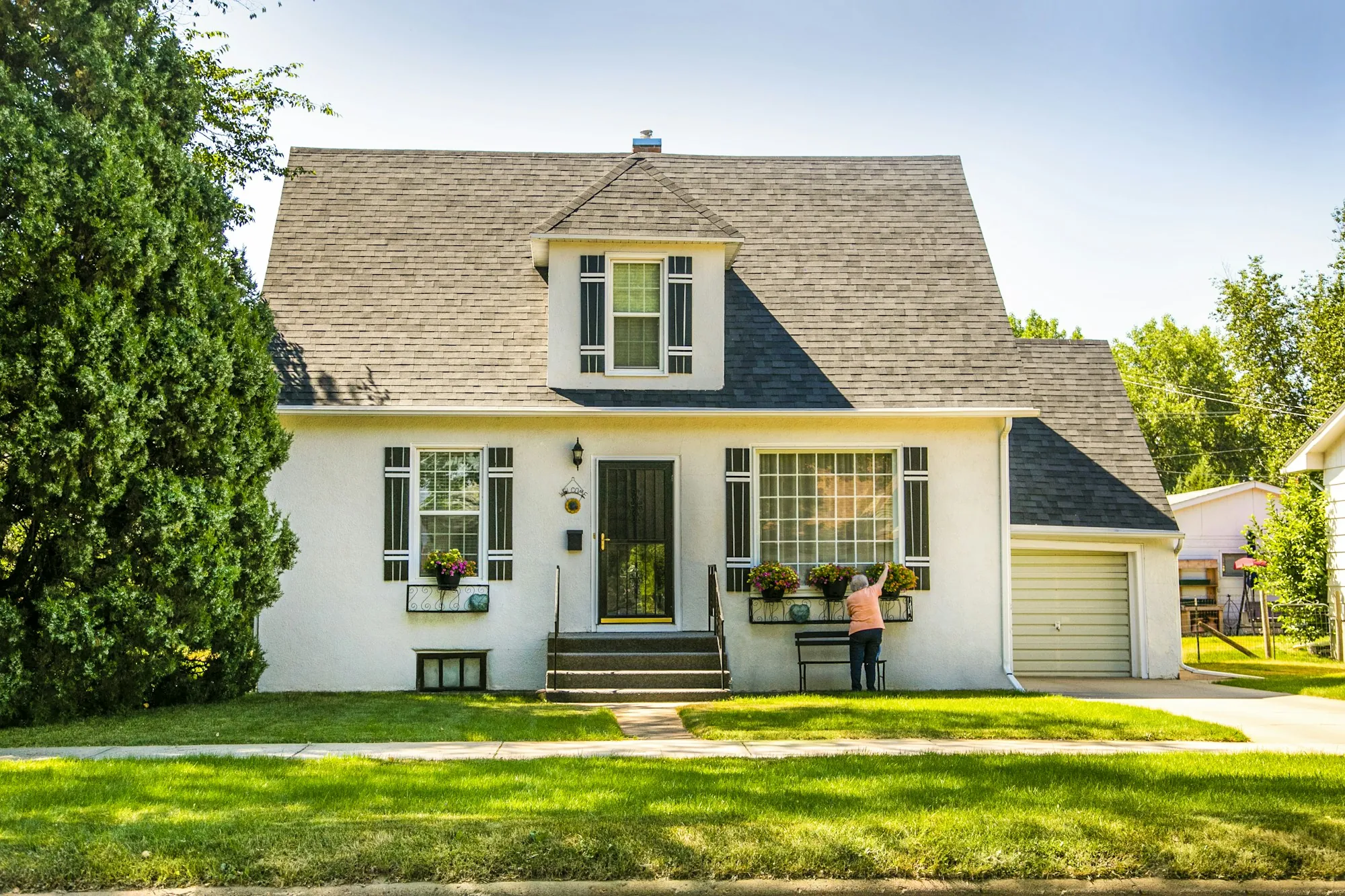 The story of Laguna Hills Water Pros White house with a green lawn and trees
